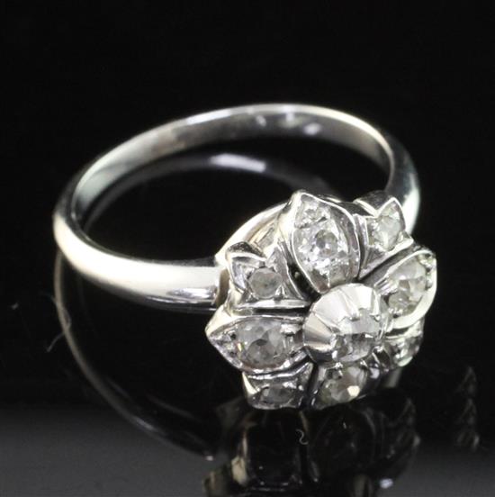 An early 20th century white gold and diamond cluster ring, size M.